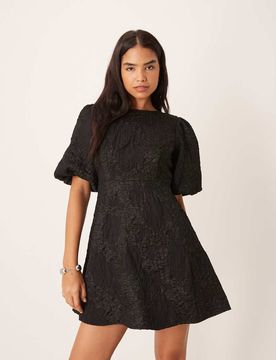 Robe courte en jacquard à manches bouffantes et nauds dans le dos - Noir S