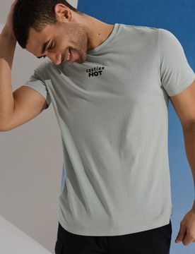 T-shirt in cotone con scritta Caution Hot - verde menta